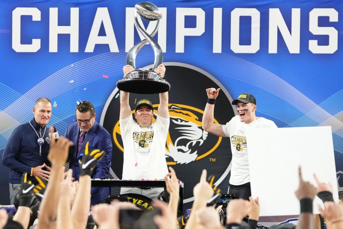 Missouri Tigers head coach Eliah Drinkwitz hoists the Field Scovell Trophy following their 14-3 win over the Ohio State Buckeyes in the Goodyear Cotton Bowl Classic at AT&T Stadium.